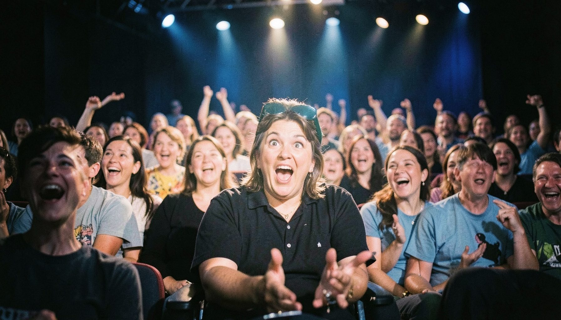 A television studio audience laughing and reacting with surprise, warm stage lighting, lively and entertaining mood